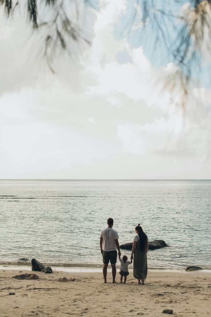 A family enjoys a tranquil day at the beach, highlighting togetherness and love.