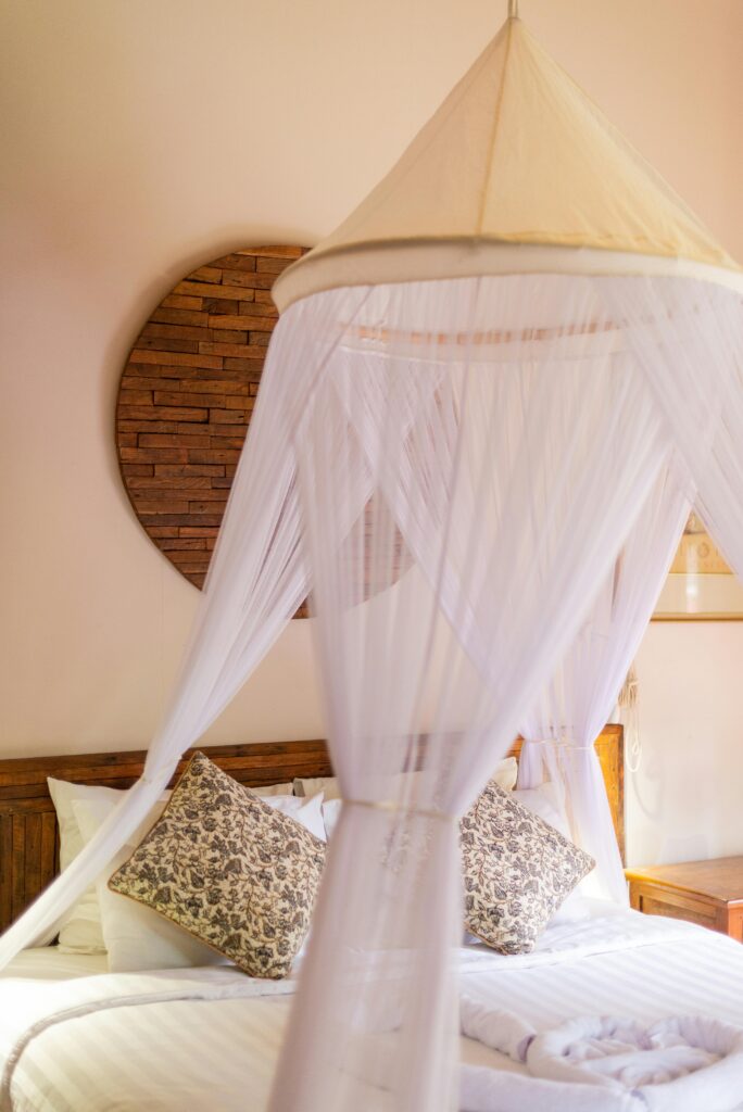 Experience serene luxury with this beautifully adorned canopy bed in a Bali villa, ideal for relaxation.