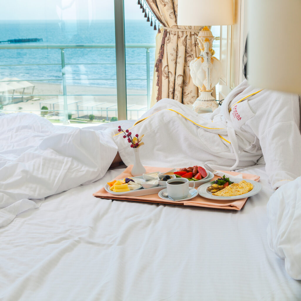 side view breakfast with coffee cup and omelette in plate on hotel room